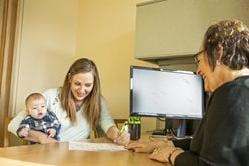 Woman happily signing form